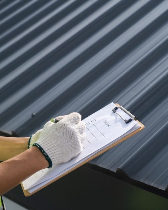 Inspector completing a roof checklist